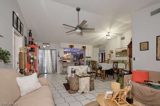 tiled living room with vaulted ceiling and ceiling fan