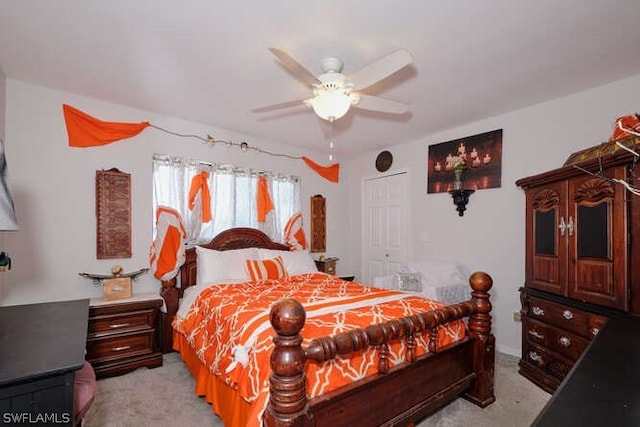 bedroom featuring ceiling fan and light carpet