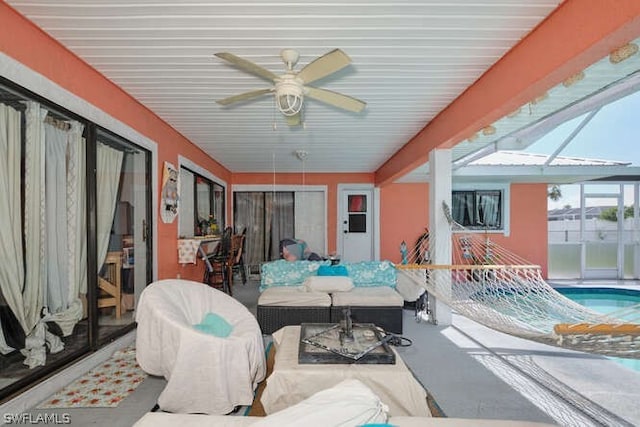 sunroom / solarium featuring ceiling fan