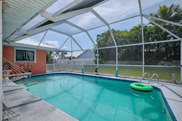 view of pool with glass enclosure