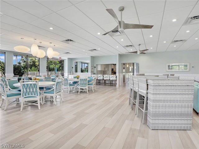 dining area with ceiling fan and light hardwood / wood-style flooring