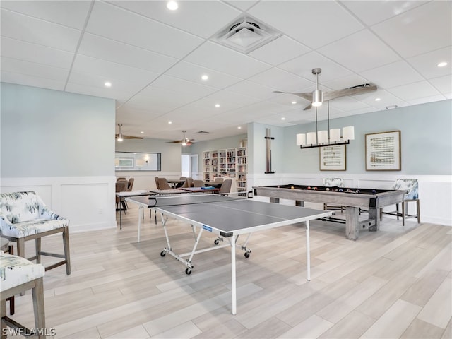 recreation room with ceiling fan, light wood-type flooring, a paneled ceiling, and pool table