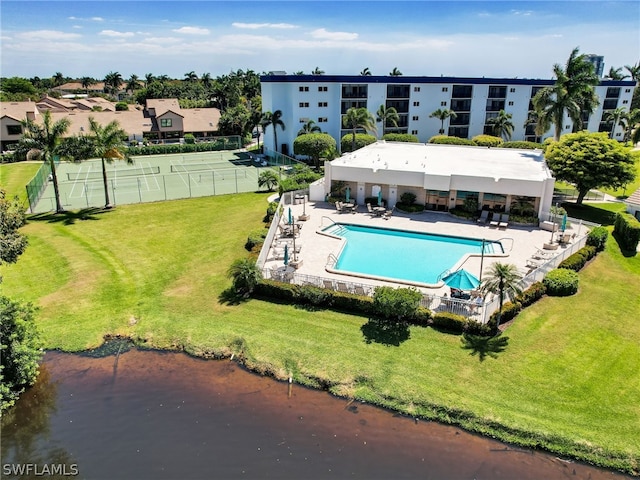 view of swimming pool featuring a yard and a patio