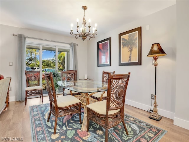 dining area with a notable chandelier and light wood-type flooring