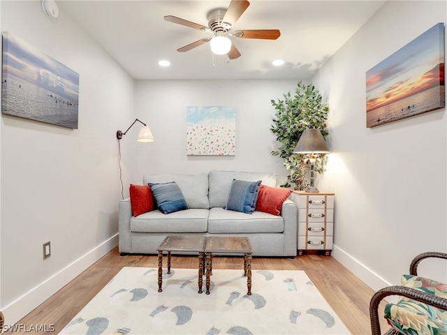 living room featuring ceiling fan and light hardwood / wood-style floors