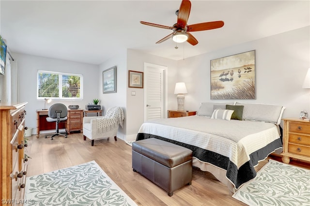 bedroom with light hardwood / wood-style flooring and ceiling fan