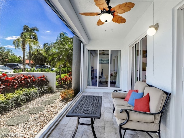 sunroom featuring ceiling fan