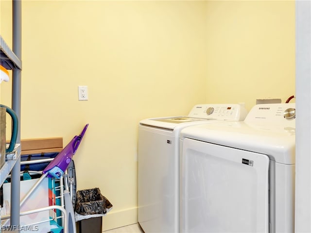 clothes washing area with washing machine and dryer