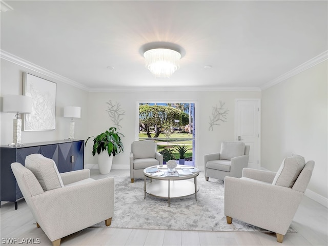 living room with a notable chandelier and ornamental molding