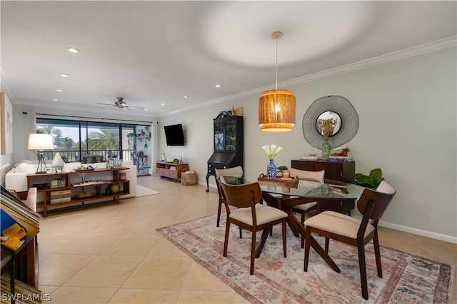 dining room with ceiling fan, crown molding, and light tile flooring