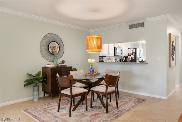 dining room with ornamental molding and light tile floors