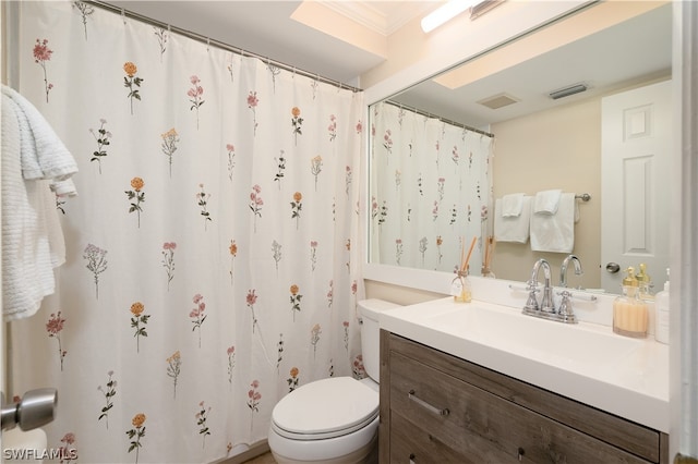 bathroom with large vanity, toilet, and ornamental molding