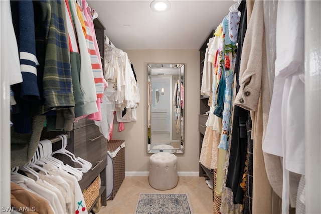 spacious closet featuring light tile flooring