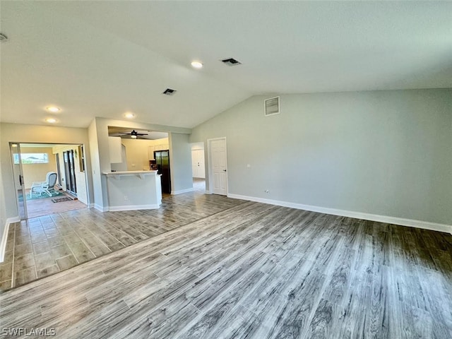 unfurnished living room with ceiling fan, lofted ceiling, and light hardwood / wood-style floors