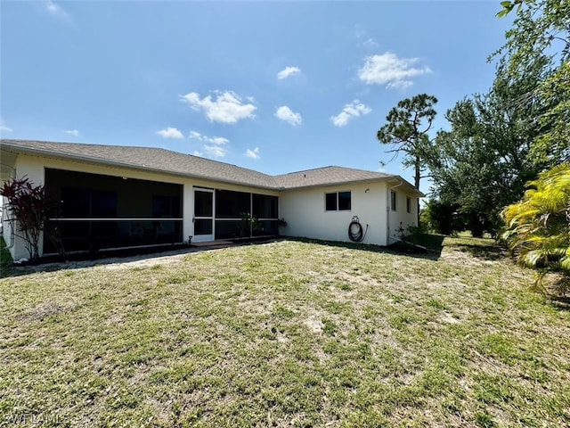 back of house featuring a lawn