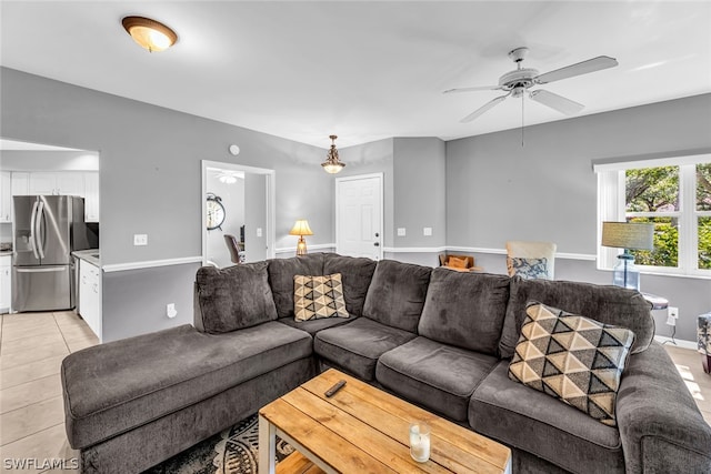 tiled living room with ceiling fan