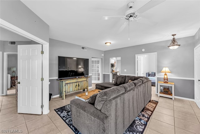 living room with ceiling fan and light tile floors