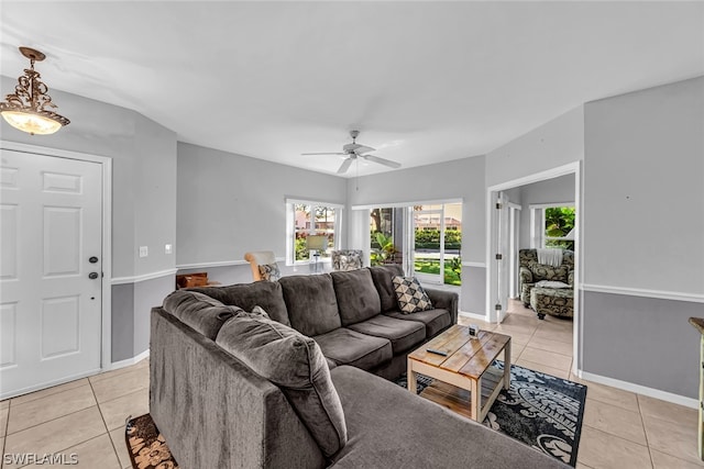 living room with plenty of natural light, ceiling fan, and light tile floors