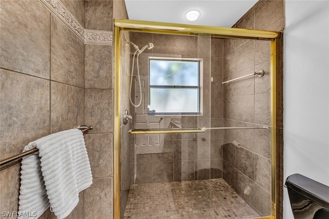 bathroom featuring an enclosed shower and toilet