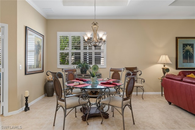 tiled dining area featuring an inviting chandelier, ornamental molding, and a raised ceiling