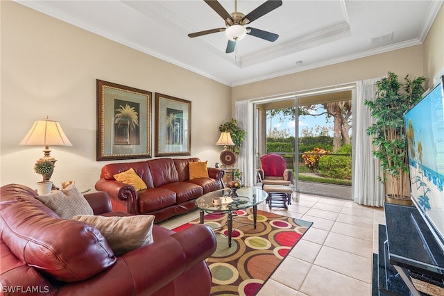 tiled living room featuring crown molding, ceiling fan, and a raised ceiling