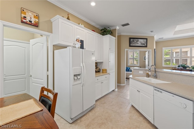 kitchen with white cabinets, crown molding, light tile floors, white appliances, and sink