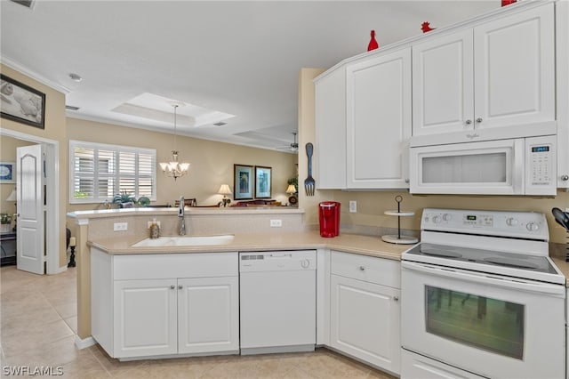 kitchen featuring an inviting chandelier, white appliances, sink, and kitchen peninsula