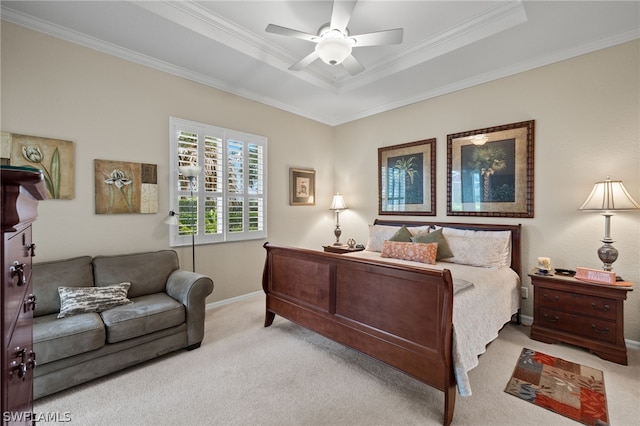 bedroom featuring ceiling fan, crown molding, a raised ceiling, and light carpet