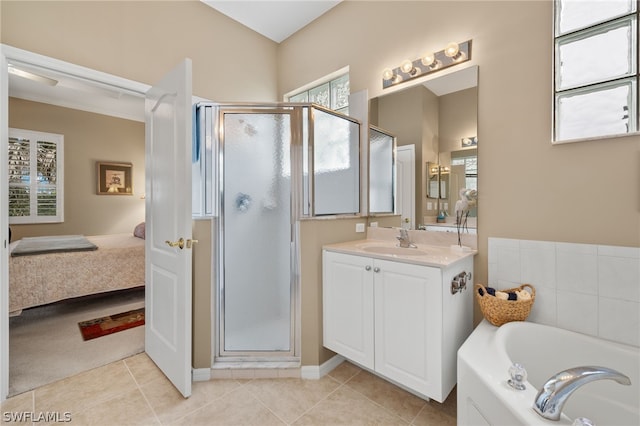 bathroom with vanity, independent shower and bath, and tile floors