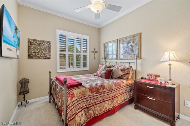 carpeted bedroom featuring ceiling fan and ornamental molding