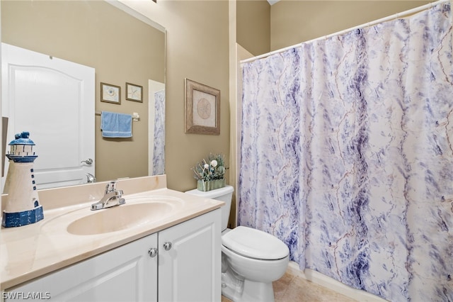 bathroom featuring tile flooring, toilet, and vanity