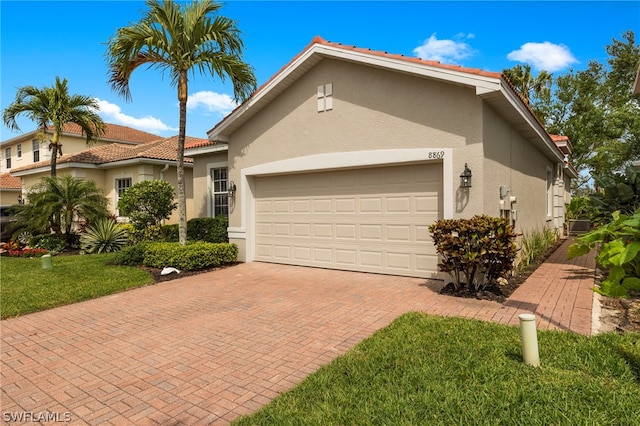 exterior space featuring central AC, a garage, and a front lawn