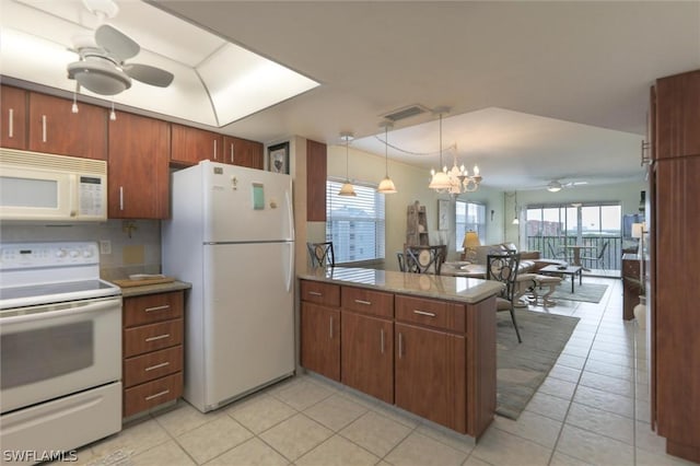 kitchen featuring kitchen peninsula, white appliances, light tile patterned flooring, hanging light fixtures, and ceiling fan with notable chandelier