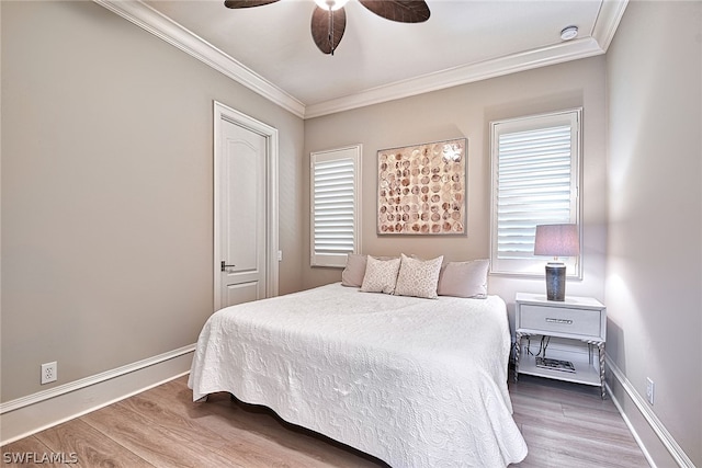 bedroom with ceiling fan, crown molding, and hardwood / wood-style floors