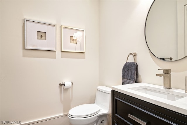 bathroom with toilet and vanity