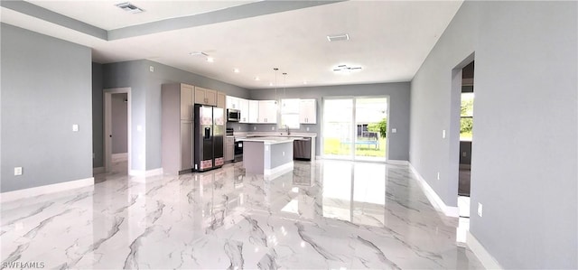 kitchen with light countertops, appliances with stainless steel finishes, visible vents, and baseboards