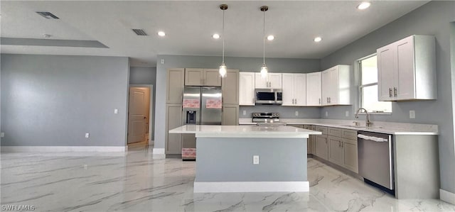 kitchen featuring marble finish floor, light countertops, visible vents, appliances with stainless steel finishes, and a kitchen island