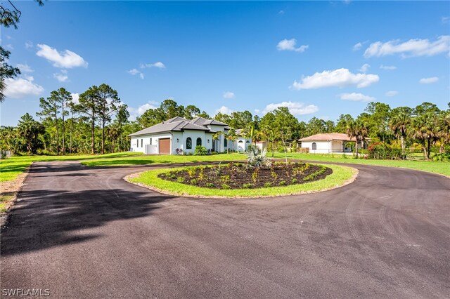 view of front of house with a garage and a front yard