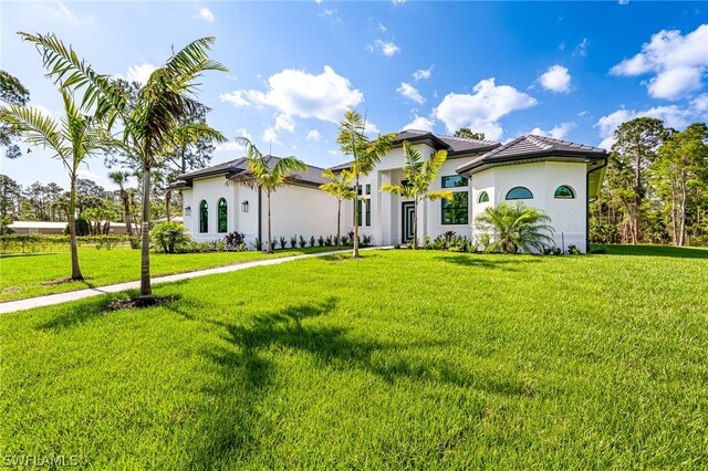 mediterranean / spanish-style home featuring a front yard