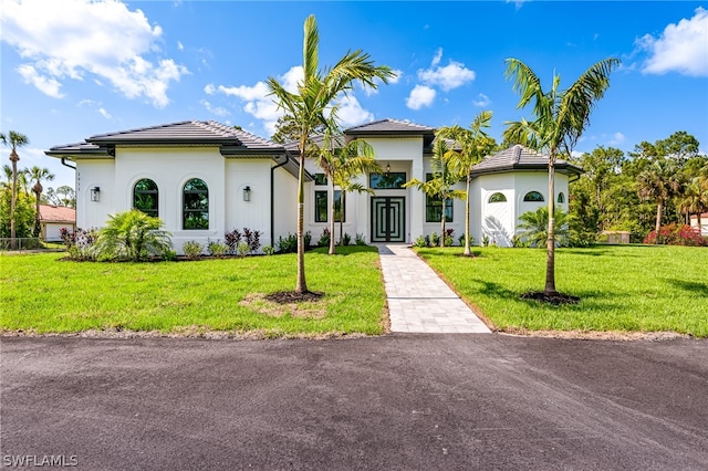 mediterranean / spanish-style house with a front lawn