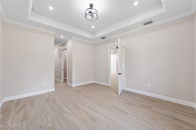 spare room featuring ornamental molding and a tray ceiling