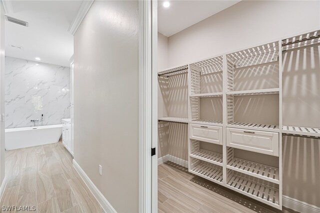 walk in closet featuring light hardwood / wood-style floors