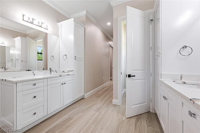 bathroom with ornamental molding, hardwood / wood-style floors, and vanity