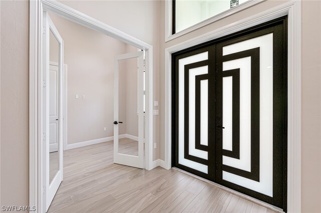 entryway featuring light hardwood / wood-style floors and french doors