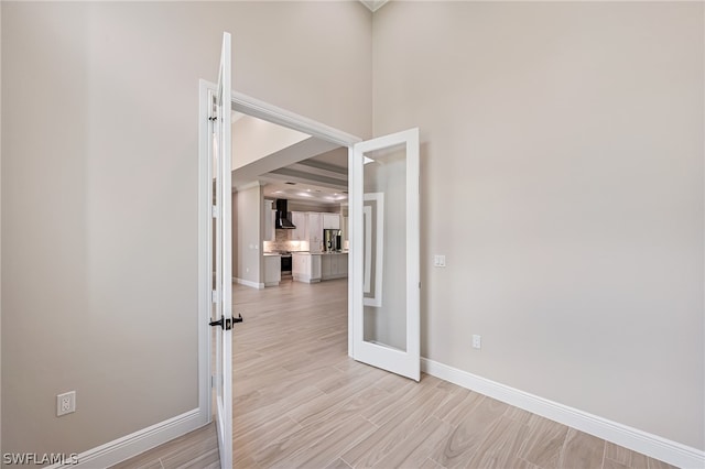 interior space with a high ceiling and light hardwood / wood-style flooring