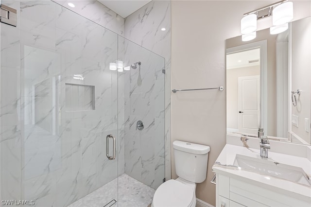 bathroom with a shower with shower door, vanity, and toilet