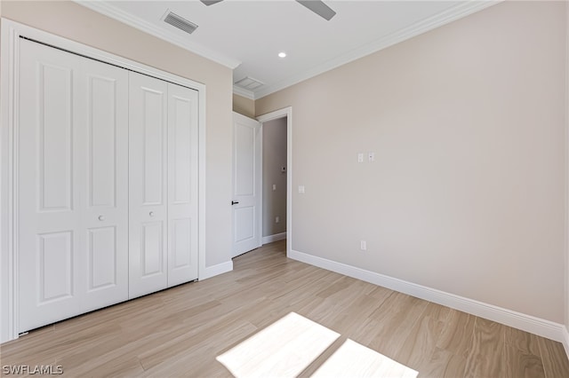 unfurnished bedroom featuring ornamental molding, a closet, ceiling fan, and light hardwood / wood-style flooring