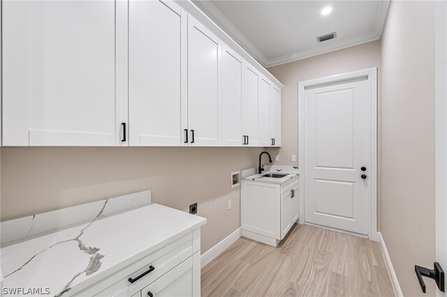 clothes washing area featuring cabinets, electric dryer hookup, ornamental molding, hookup for a washing machine, and sink