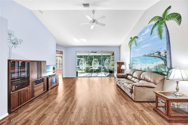 living room featuring hardwood / wood-style flooring, ceiling fan, and vaulted ceiling