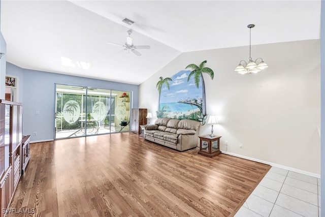 living room featuring ceiling fan with notable chandelier, wood-type flooring, and lofted ceiling